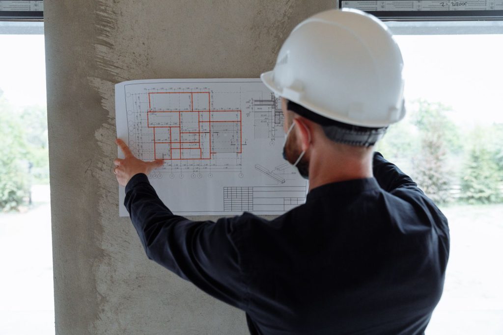 Engineer reviewing plumbing drawings at a job site