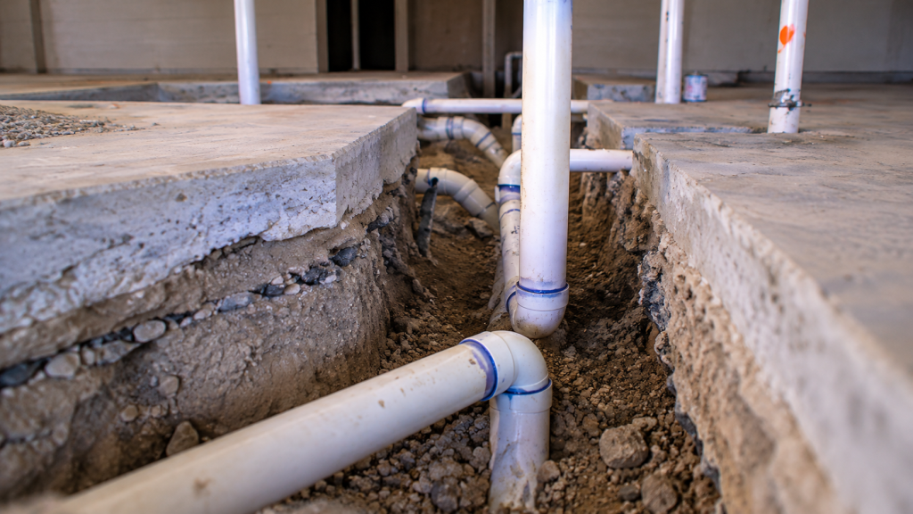 Close-up of underground waste line in a trench