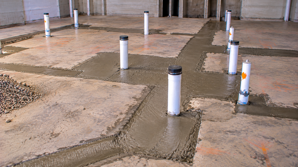 Tenant improvement plumbing risers in a finished slab